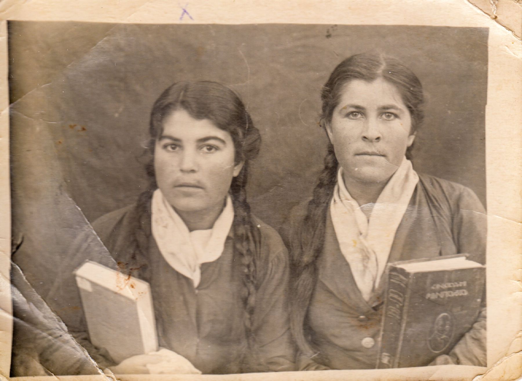 Two young women with plaits hold books, in an old print