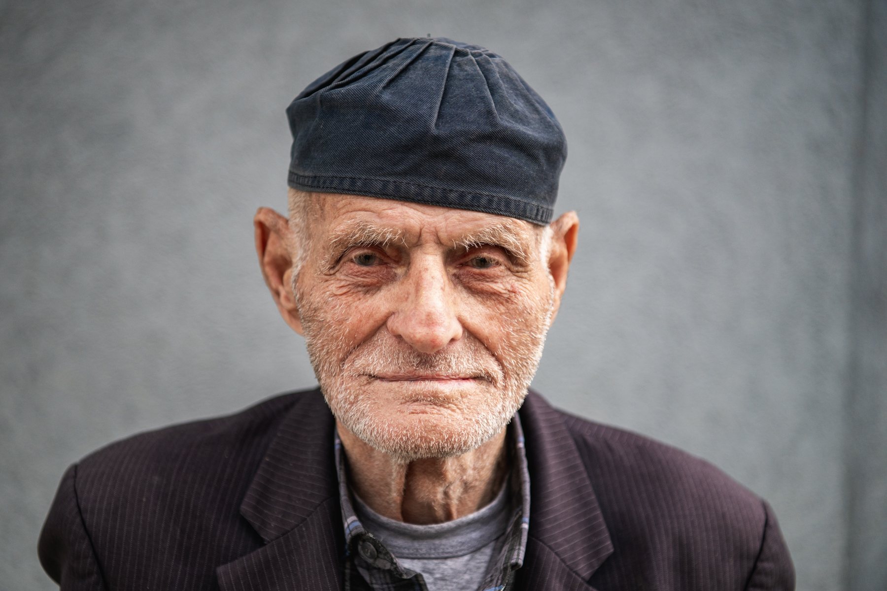 Portrait of a very old man in a dark cap