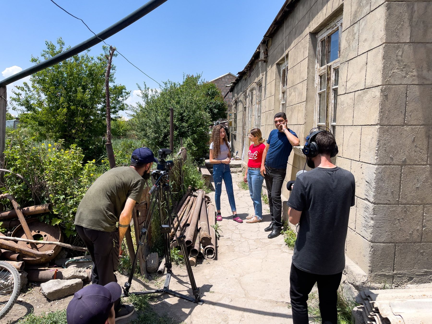 The film crew sets up a camera on a village street in Armenia