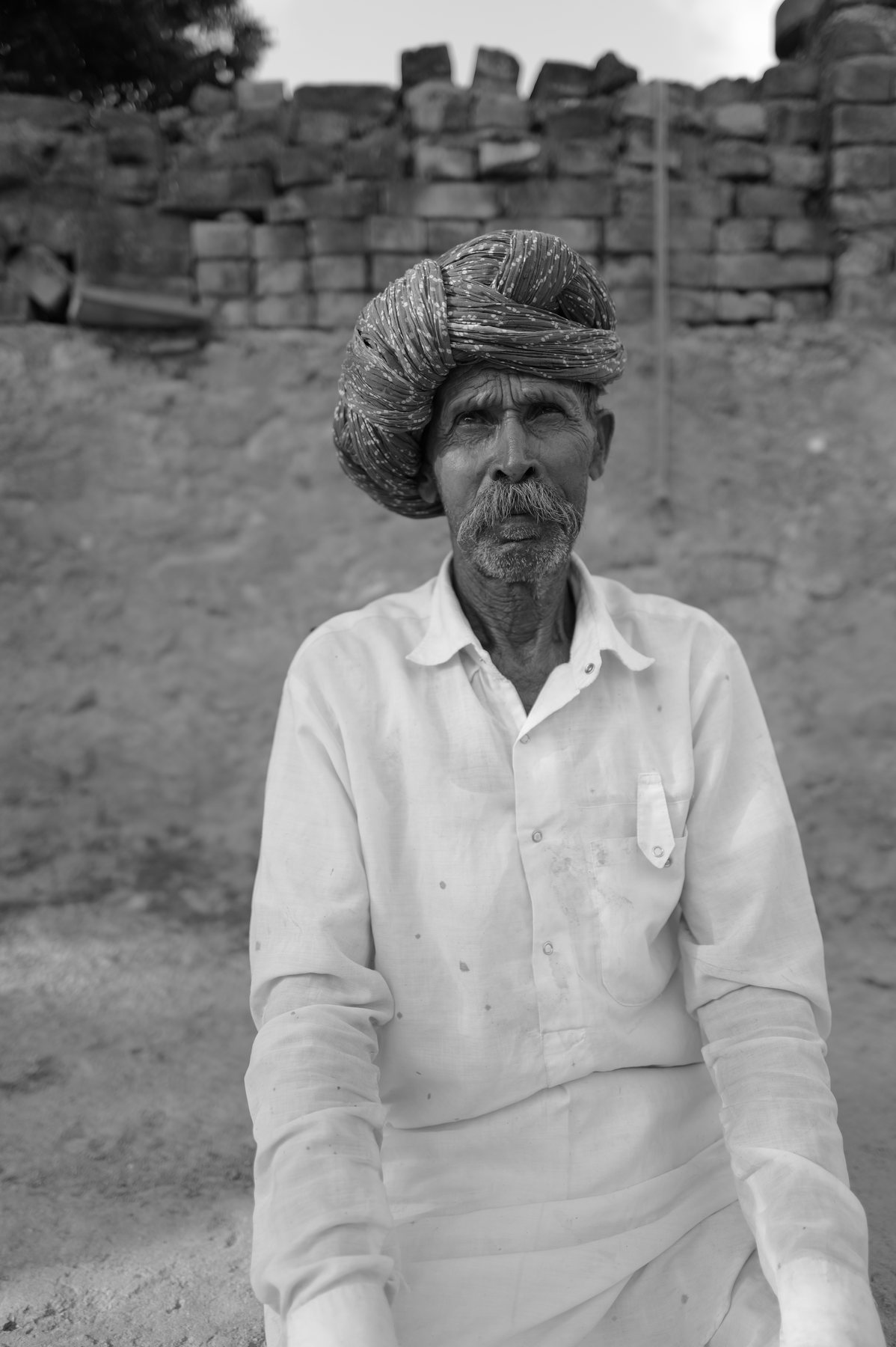 The same man, closer, looking straight into the lens