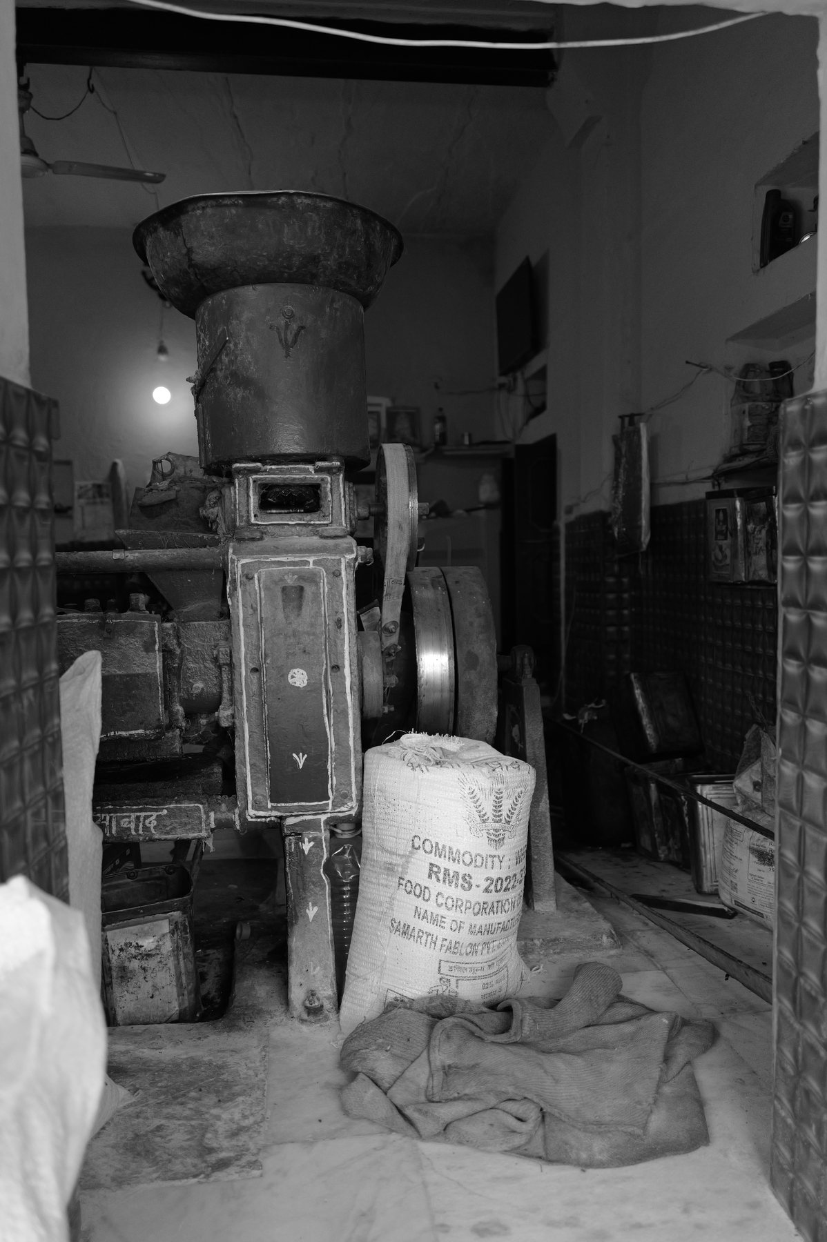 The tall grinding mill with a sack at its foot